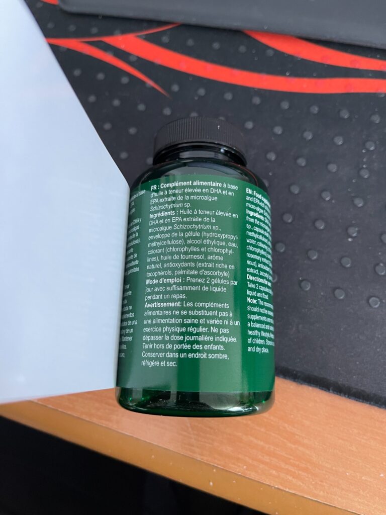 L'arrière de la bouteille d'oméga-3 végétaliens, montrant l'étiquette nutritionnelle et les avertissements en plusieurs langu...
