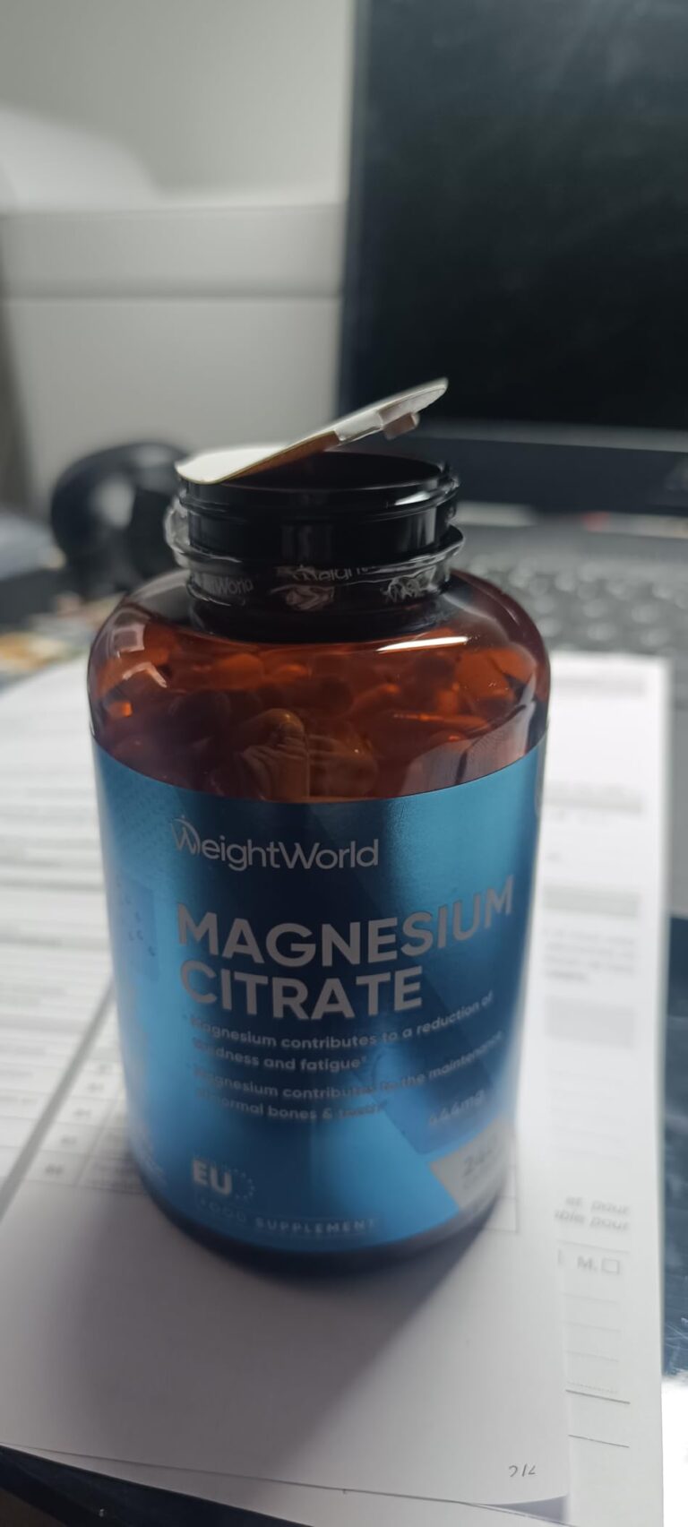 Flacon de citrate de magnésium sur un bureau.