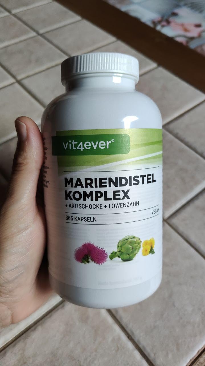 Bouteille de Mariendistel Komplex (chardon-marie) de la marque Vit4ever tenue dans une main.