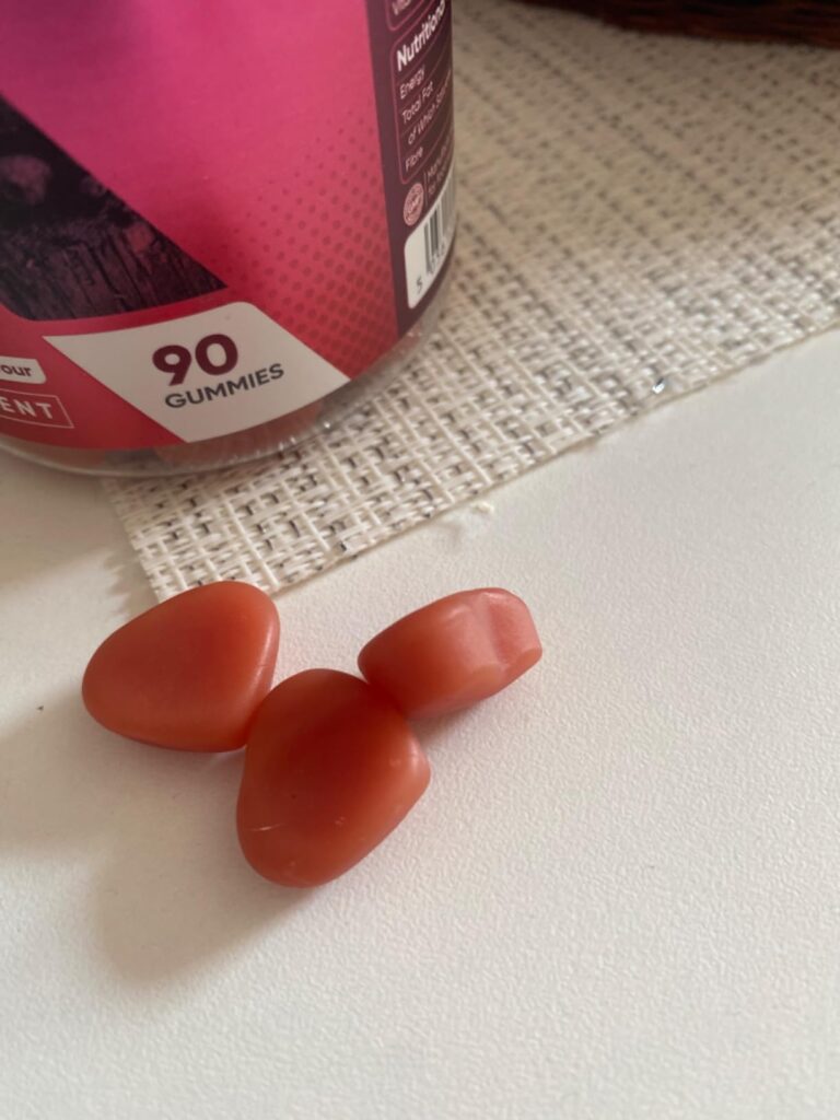 Trois gommes sur une table, avec le pot en arrière-plan. La forme des gommes est irrégulière, comme un fruit. Les gommes sont...