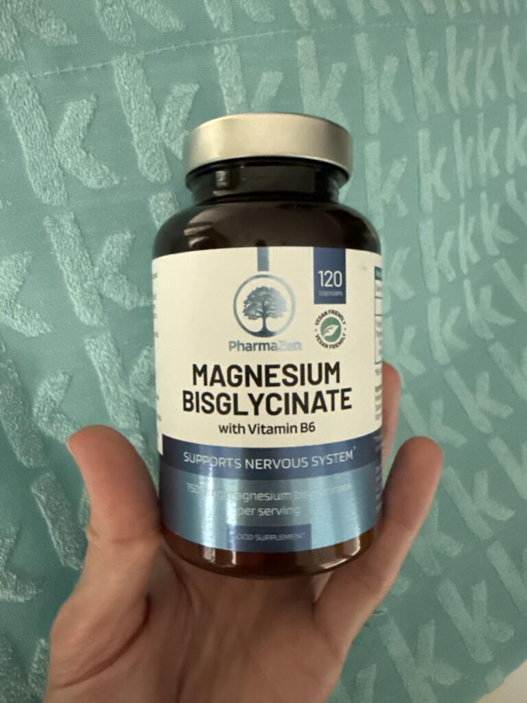 Bouteille de magnésium PharmaZen, tenue en main avec le couvercle argenté et l'étiquette bien visible.
